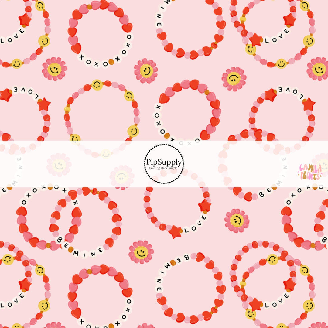 This holiday fabric by the yard features heart bracelets on pink. This festive pattern fabric can be used for all your sewing and crafting needs!