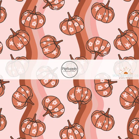 These autumn themed pattern fabric by the yard features the following design elements: burnt orange pumpkins on wavy pattern. This fun themed fabric can be used for all your sewing and crafting needs!