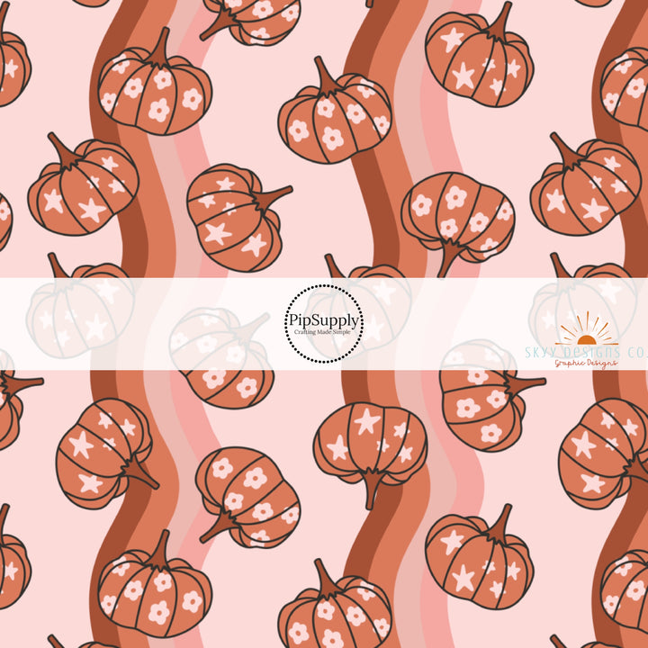 These autumn themed pattern fabric by the yard features the following design elements: burnt orange pumpkins on wavy pattern. This fun themed fabric can be used for all your sewing and crafting needs!