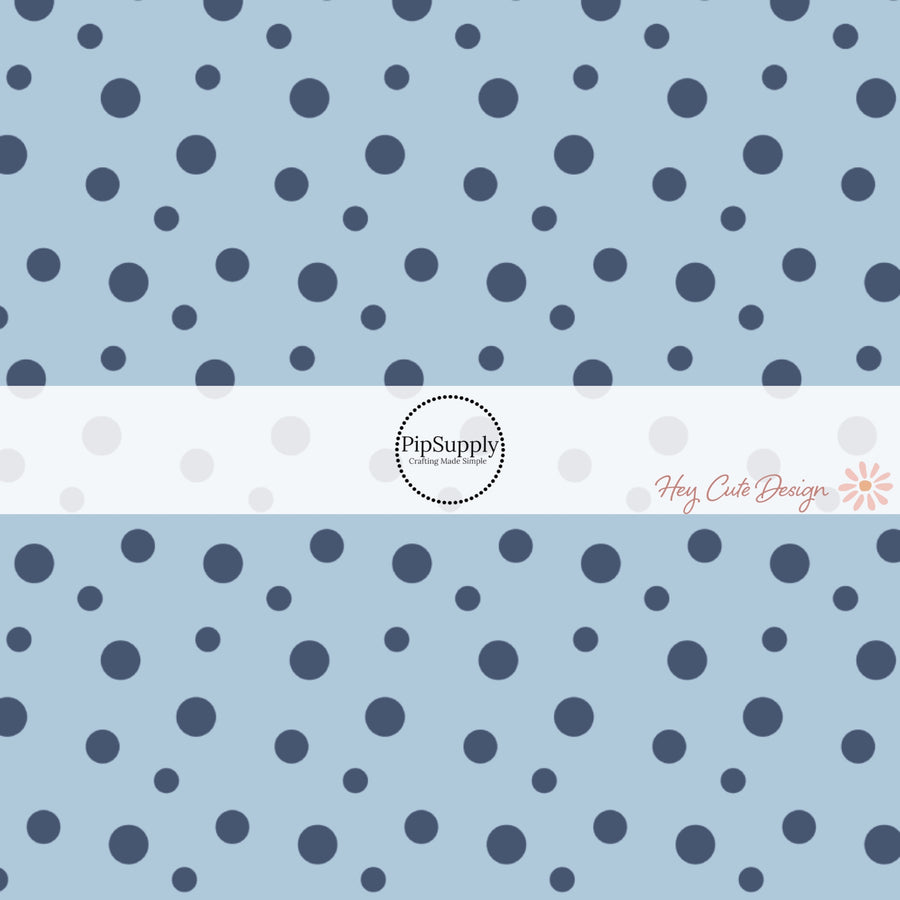 These dot themed light blue fabric by the yard features small dark navy blue dots on light blue. 