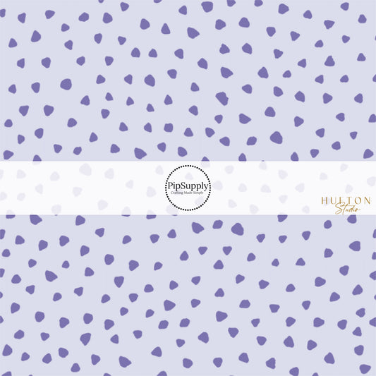 These dot themed light purple fabric by the yard features dark purple small dots on pale purple. This fun dot themed fabric can be used for all your sewing and crafting needs! 