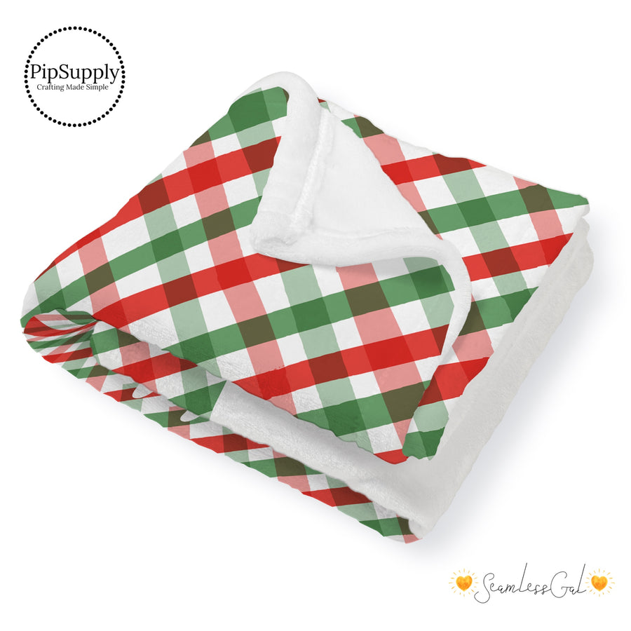 This winter designer pattern is printed onto the front side of our soft touch minky blankets. The backside will not be printed and left the natural cream/white color of the blanket. This print pattern features colorful Christmas gingham pattern.