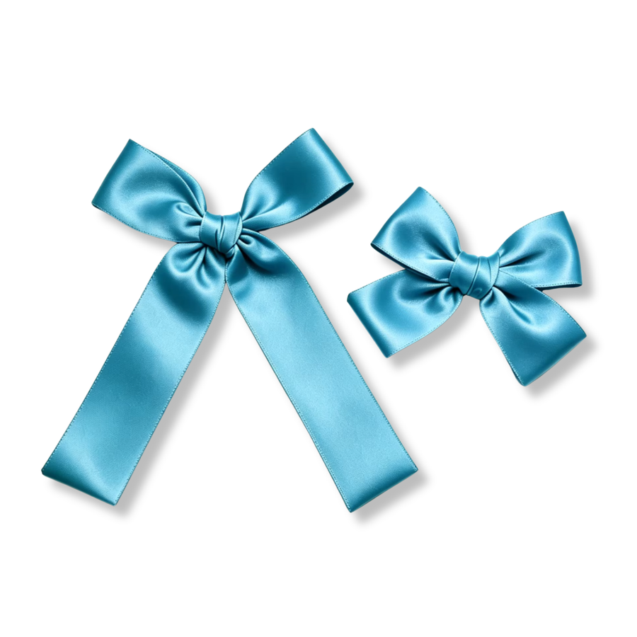 Large Bow
A long-tail satin bow made from wide aqua-blue ribbon with smooth, structured loops draped tails.  Finished with a neatly wrapped center knot, this bow is perfect for ponytails, special occasions, dance recitals, school uniforms, or everyday elegance.
Small Bow
A coordinating petite satin bow featuring the same rich aqua-blue satin and glossy finish. Its compact size and classic shape make it ideal for pigtails, half-up hairstyles, or sibling sets.
Small Sizing 4.5" x 4.5"
Large Sizing 5.5 x 7" 