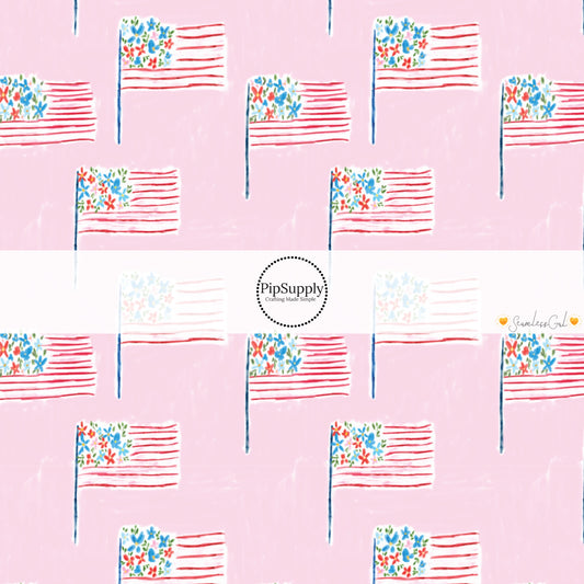 This 4th of July fabric by the yard features patterned American flags on light pink. This fun patriotic themed fabric can be used for all your sewing and crafting needs!