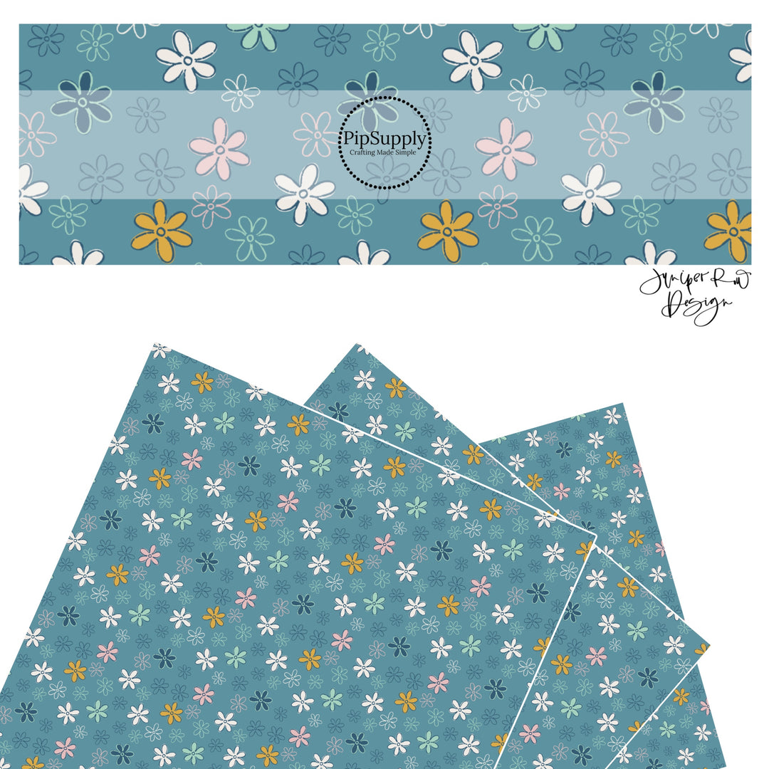 Yellow, pink, white, and blue drawn flowers on blue faux leather sheets