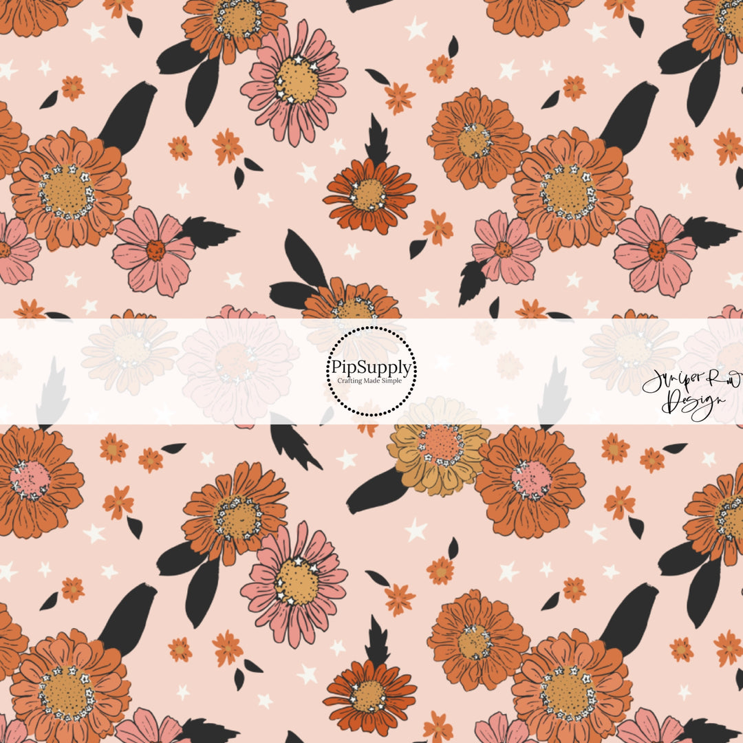 These Halloween themed pattern fabric by the yard features the following design elements: multi color flowers on light pink. This fun spooky themed fabric can be used for all your sewing and crafting needs!