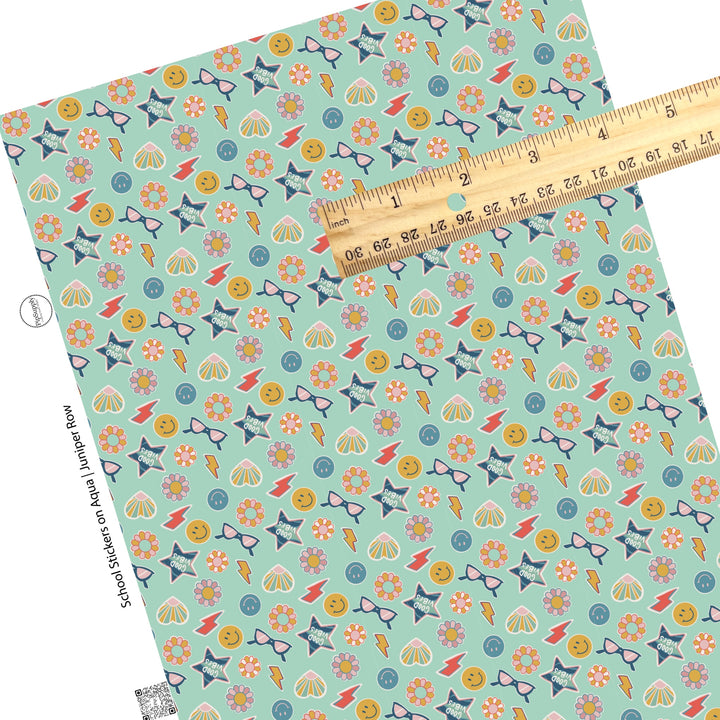 Scattered fun stickers on aqua faux leather sheets