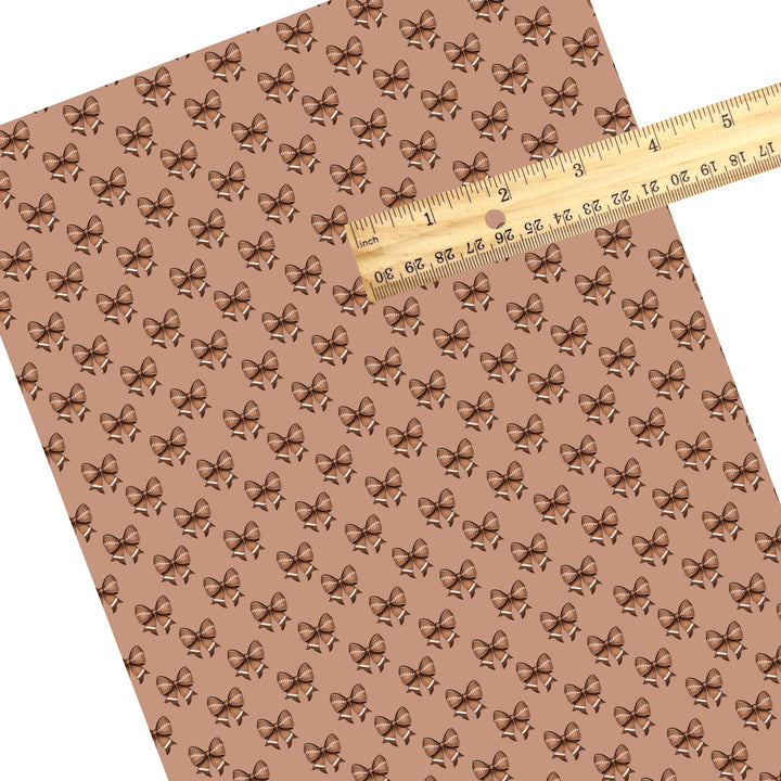 These sport themed faux leather sheets contain the following design elements: brown football bows. Our CPSIA compliant faux leather sheets or rolls can be used for all types of crafting projects.