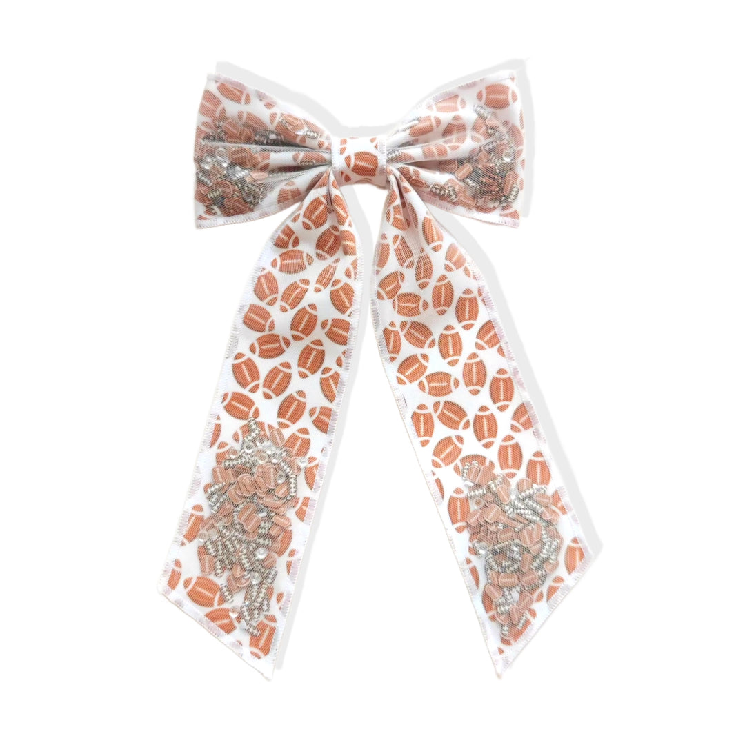 These sports pattern long tail shaker tied bows are ready to package and resell to your customers no sewing or measuring necessary! These hair bows come with a clip already attached. The shaker bow comes pre-filled with football pattern clay mix.