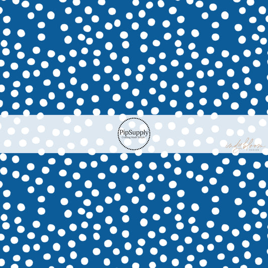 This 4th of July fabric by the yard features patriotic white dots on blue. This fun patriotic themed fabric can be used for all your sewing and crafting needs!