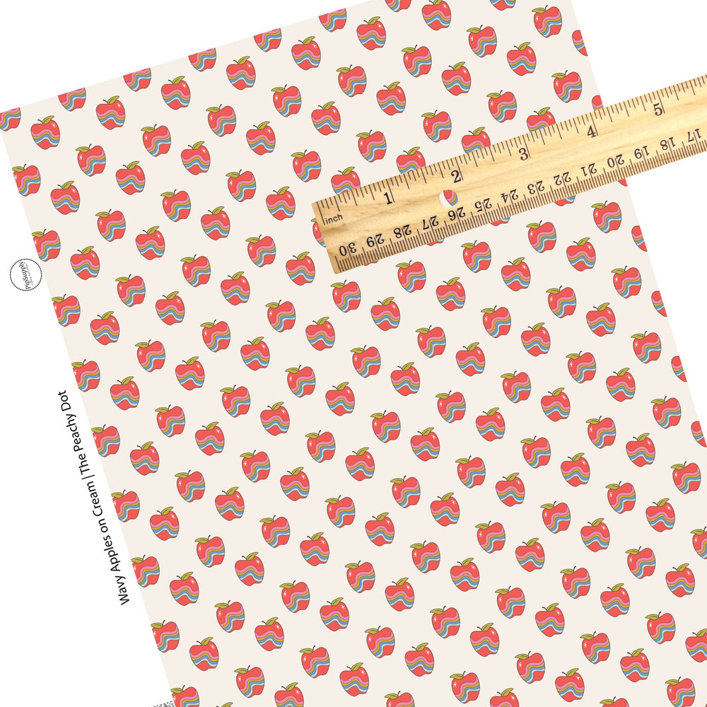 Red apples with lines on cream faux leather sheet