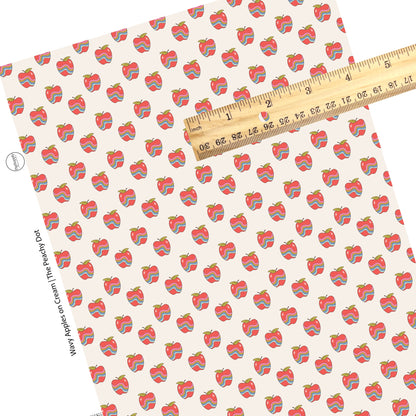 Red apples with lines on cream faux leather sheet