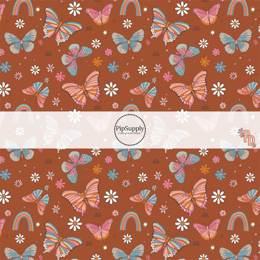 This summer fabric by the yard features multi colored butterflies surrounded by rainbows and daisies. This fun summer themed fabric can be used for all your sewing and crafting needs!