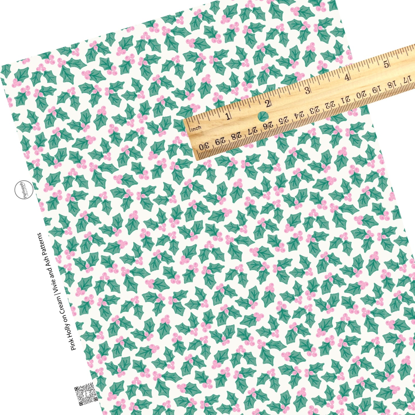 Green holly leaves and pink berries on cream faux leather sheets