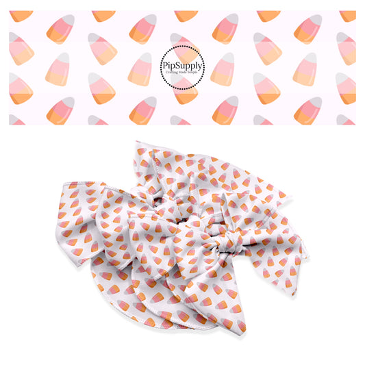 White, pink, and orange candy corns on white hair bow strips