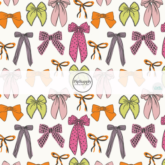 These Halloween themed pattern fabric by the yard features the following design elements: colorful pattern bows on white. This fun themed fabric can be used for all your sewing and crafting needs!