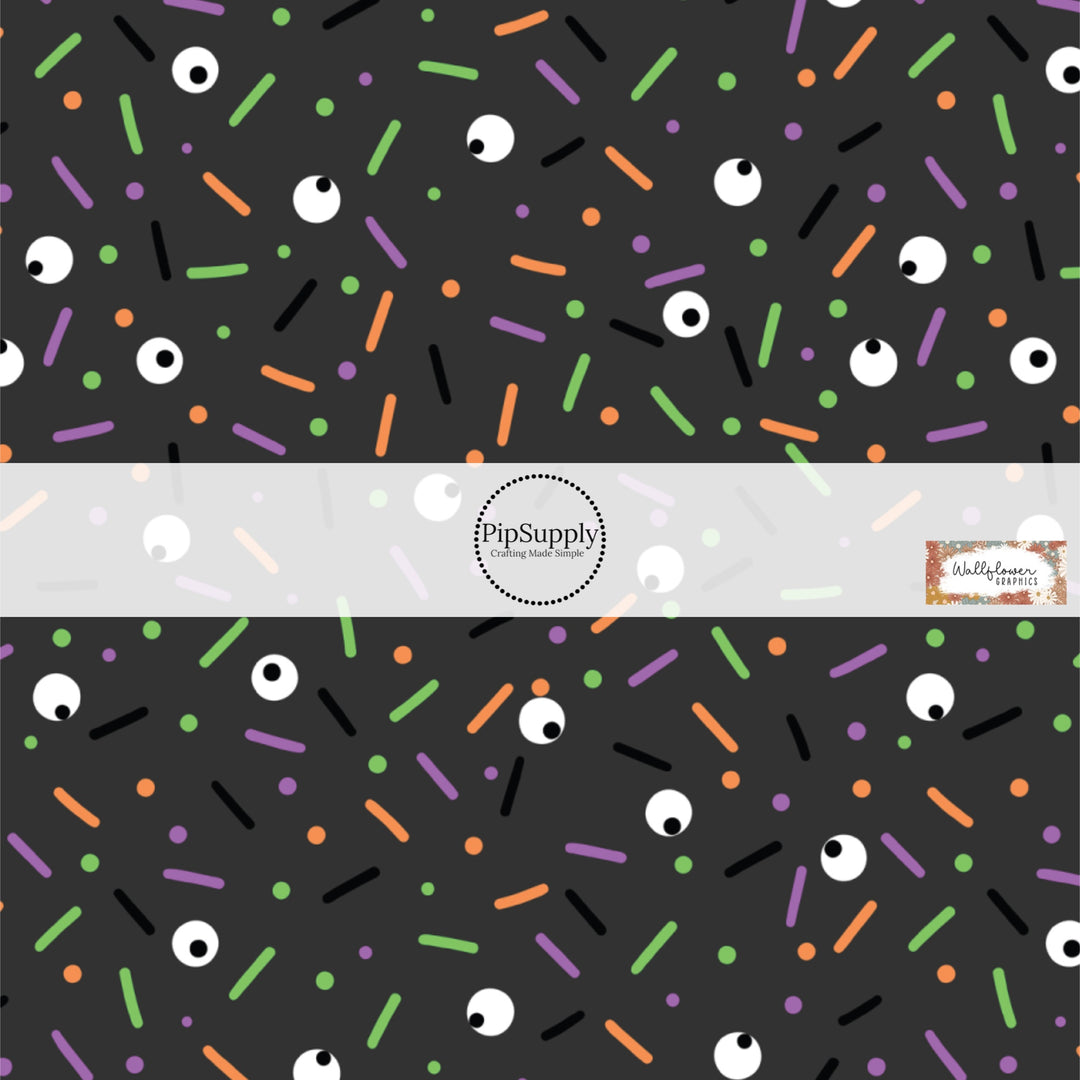 These Halloween themed pattern fabric by the yard features the following design elements: colorful sprinkles on black. This fun spooky themed fabric can be used for all your sewing and crafting needs!