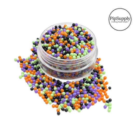 Green, orange, purple, and black tiny beads mix