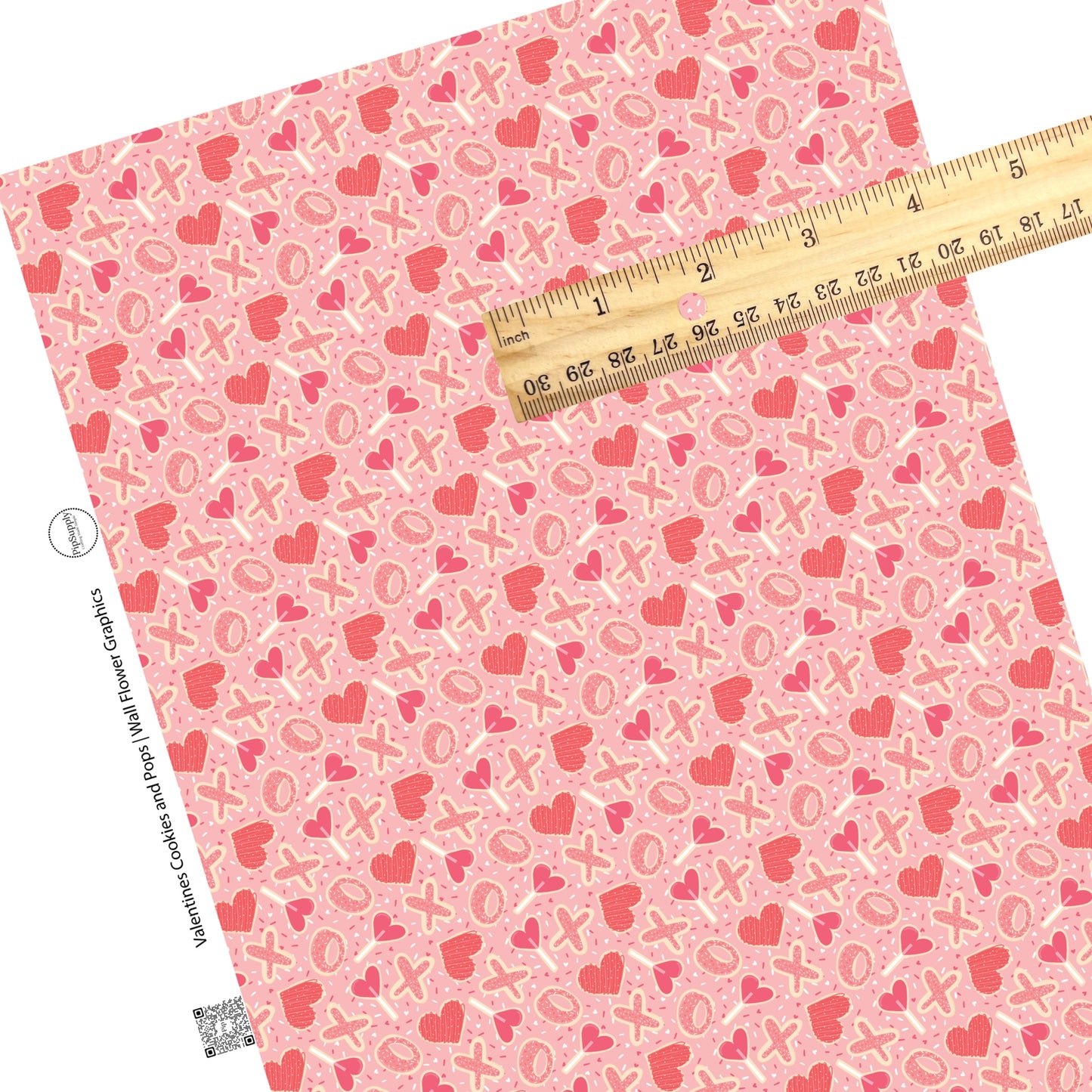 Sprinkles, hearts, lollipops, and cookies on pink faux leather sheets
