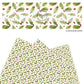 Green holly leaves with red berries on white faux leather sheets