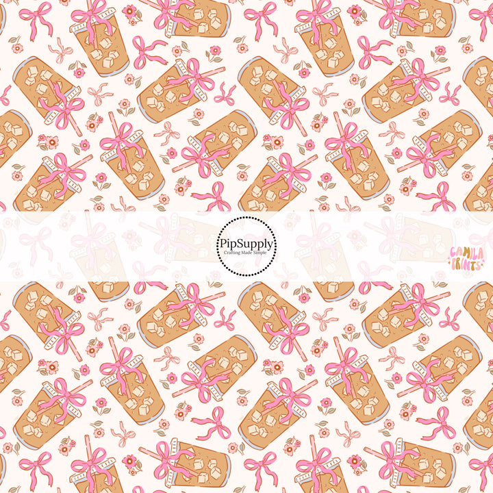 This holiday fabric by the yard features iced coffee with pink bows. This festive pattern fabric can be used for all your sewing and crafting needs! 