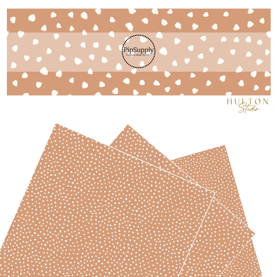 These speckled themed faux leather sheets contain the following design elements: small cream speckled dots on tan. Our CPSIA compliant faux leather sheets or rolls can be used for all types of crafting projects.