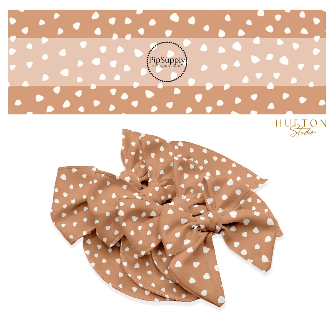 These speckled themed no sew bow strips can be easily tied and attached to a clip for a finished hair bow. These fun dot bow strips are great for personal use or to sell. The bow stripes features small cream speckled dots tan. 