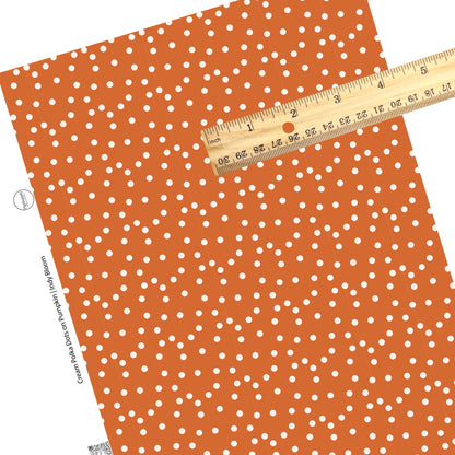These dot themed faux leather sheets contain the following design elements: small white dots on orange. Our CPSIA compliant faux leather sheets or rolls can be used for all types of crafting projects.