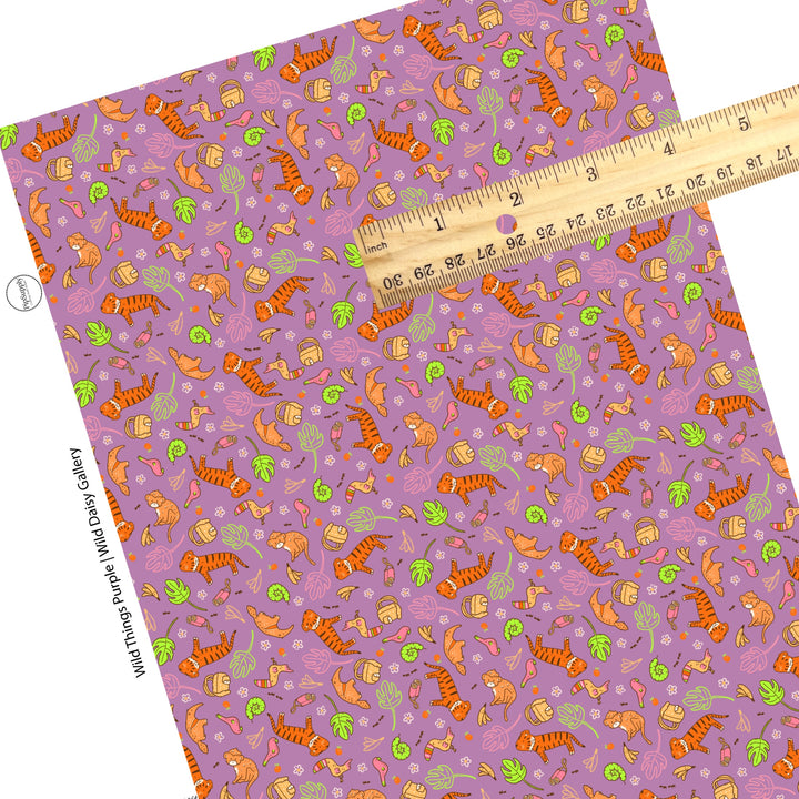 These jungle animal themed purple faux leather sheets contain the following design elements: lions, birds, snakes, monkeys, toucans, bananas, leaves and flowers. 