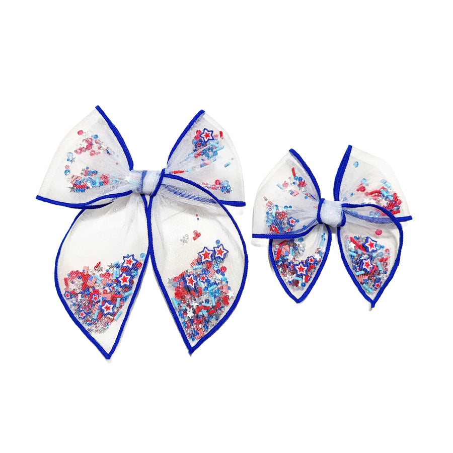 These patriotic blue serged edge pre-cut tied bows are ready to package and resell to your customers no sewing or measuring necessary! These hair bows come with a clip already attached. The shaker bows come pre-filled with patriotic star clay mix.