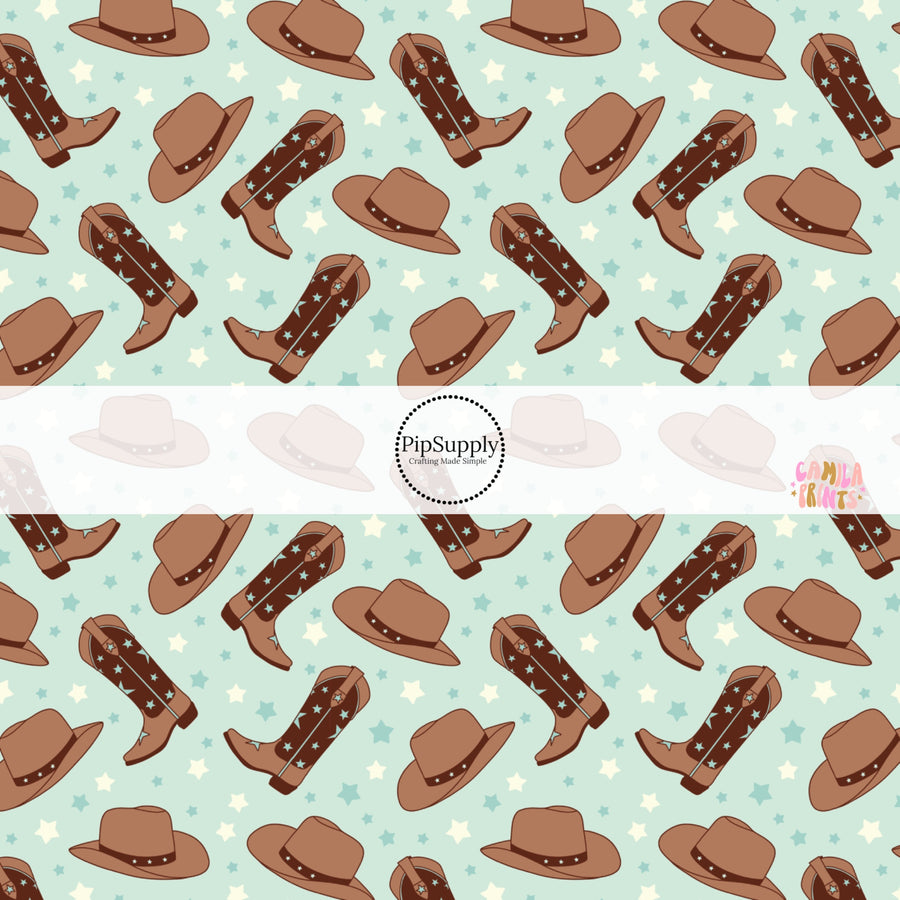 These western themed light blue pattern fabric by the yard features light blue and brown cowgirl hats and cowgirl boots along with tiny blue and cream stars. 