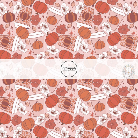 These fall pumpkin themed pink and orange fabric by the yard features pumpkin spice cups surrounded by white and pink flowers and orange pumpkins.. This fun fall themed fabric can be used for all your sewing and crafting needs! 