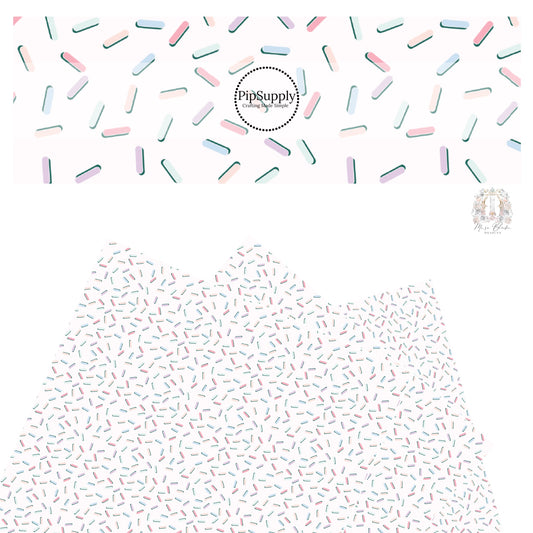 Light pink, light purple, light blue, light orange, light red, light yellow sprinkles with a green shadow on white faux leather sheet.
