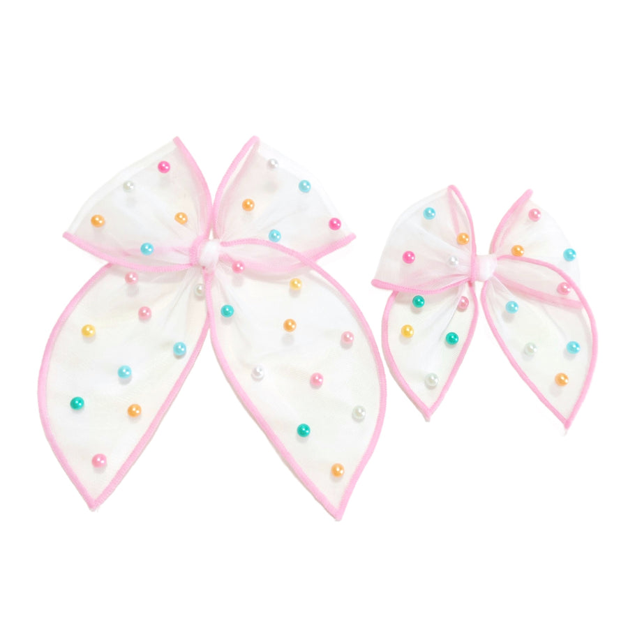 These spring tulle serged edge pre-cut tied bows with pearls are ready to package and resell to your customers no sewing or measuring necessary! These hair bows come with a clip already attached.