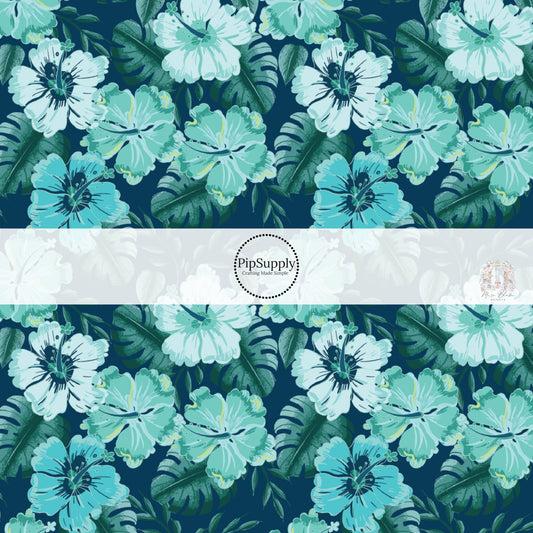 Light blue and aqua tropical flowers and palms on dark navy fabric by the yard.
