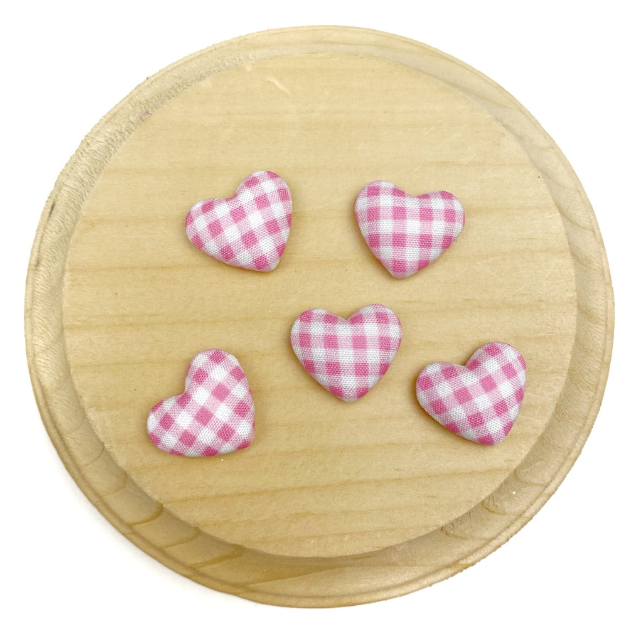 Heart-shaped flat back embellishment featuring a light  pink and white gingham plaid pattern with a softly padded, fabric-covered appearance. Finished with smooth edges and a charming, classic design, perfect for bows, hair accessories, scrapbooking, and craft projects.

Silver, flat backing
Sets of 10
Approx 1.9cm l x 1.58cm 