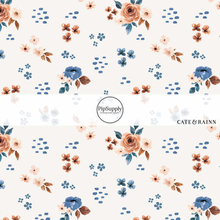 These floral themed cream fabric by the yard features cream, light pink, orange, and blue watercolor scattered floral flowers on cream. This fun floral summer themed fabric can be used for all your sewing and crafting needs! 