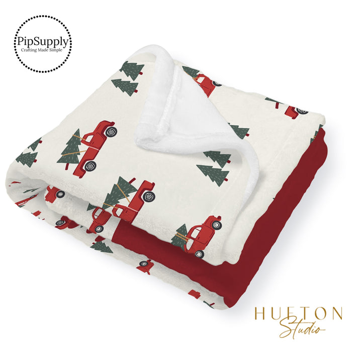 This Christmas designer pattern is printed onto the front side of our soft touch minky blankets. The backside will not be printed and left the natural cream/white color of the blanket. This print pattern features red trucks carrying Christmas trees on cream.