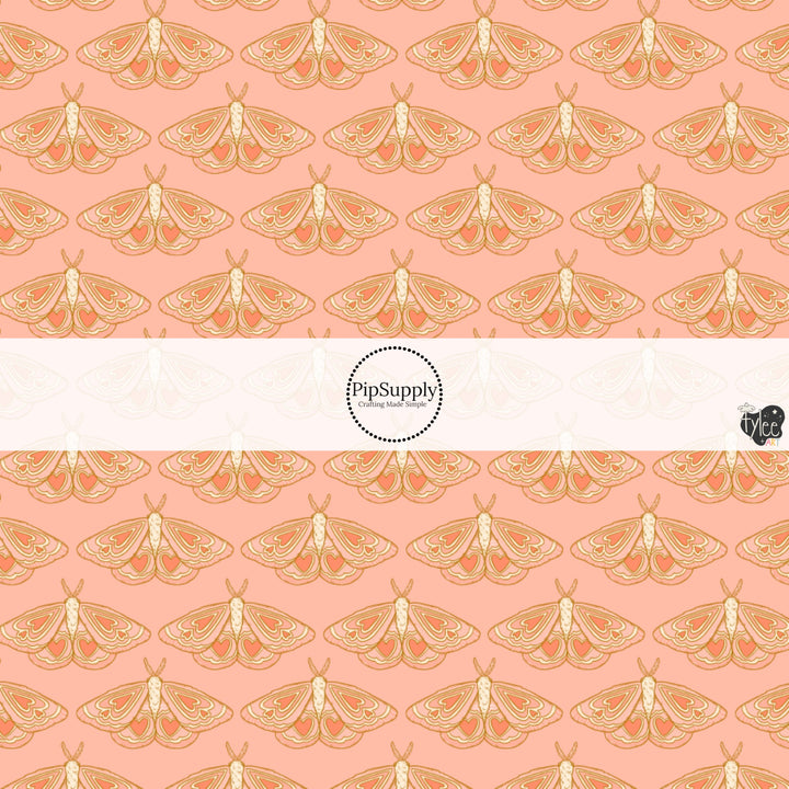 This holiday fabric by the yard features moths on pink. This festive pattern fabric can be used for all your sewing and crafting needs!