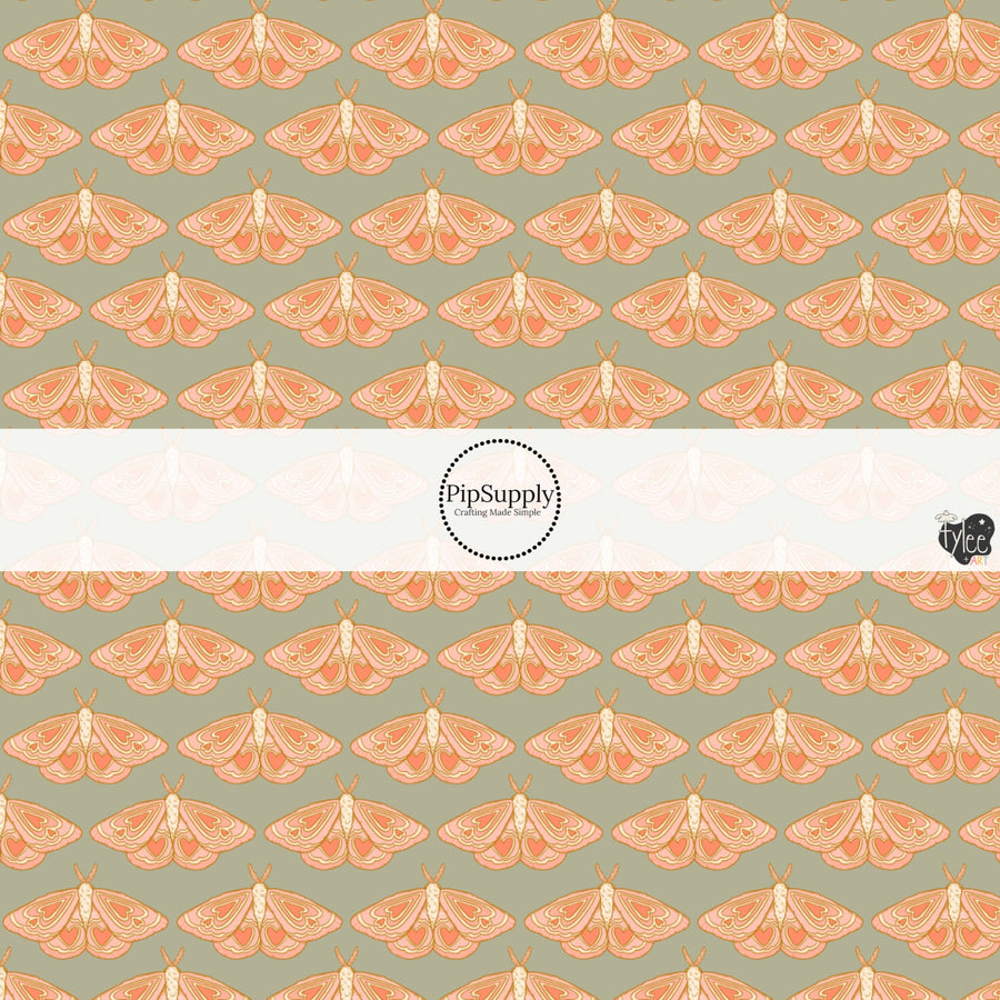 This holiday fabric by the yard features moths on sage. This festive pattern fabric can be used for all your sewing and crafting needs!