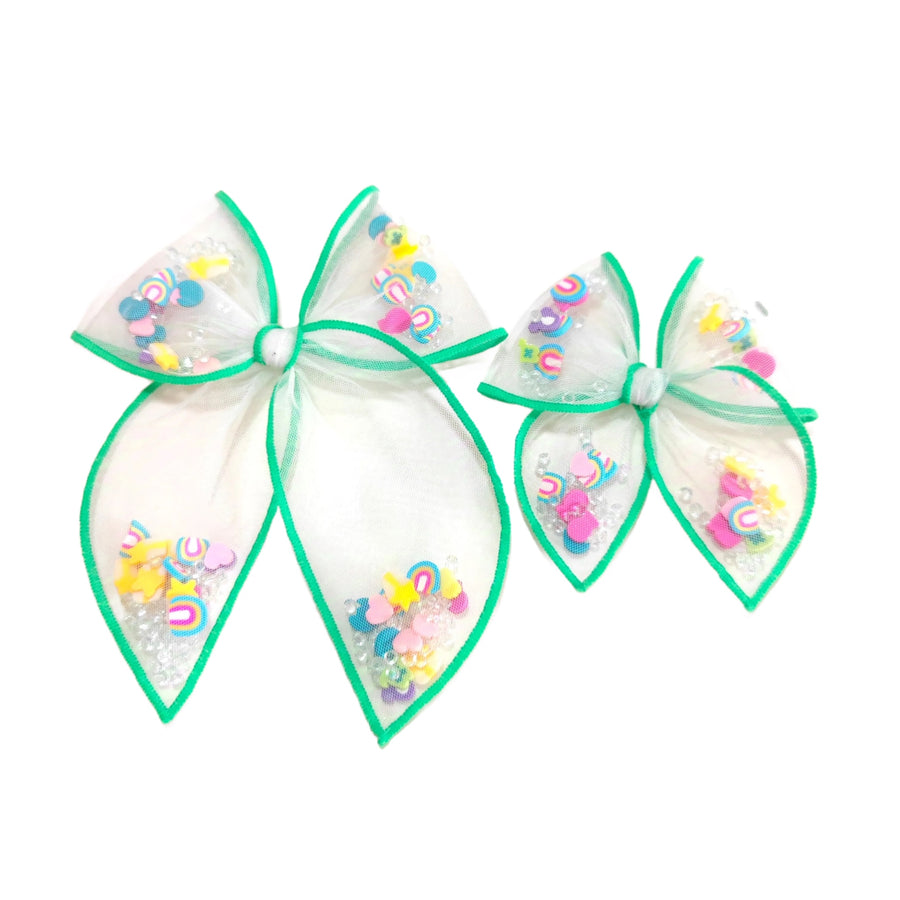 These St. Patrick's Day green stitched white tulle pre-cut shaker tied bows are ready to package and resell to your customers no sewing or measuring necessary! These hair bows come with a alligator clip already attached and come filled with lucky charms.