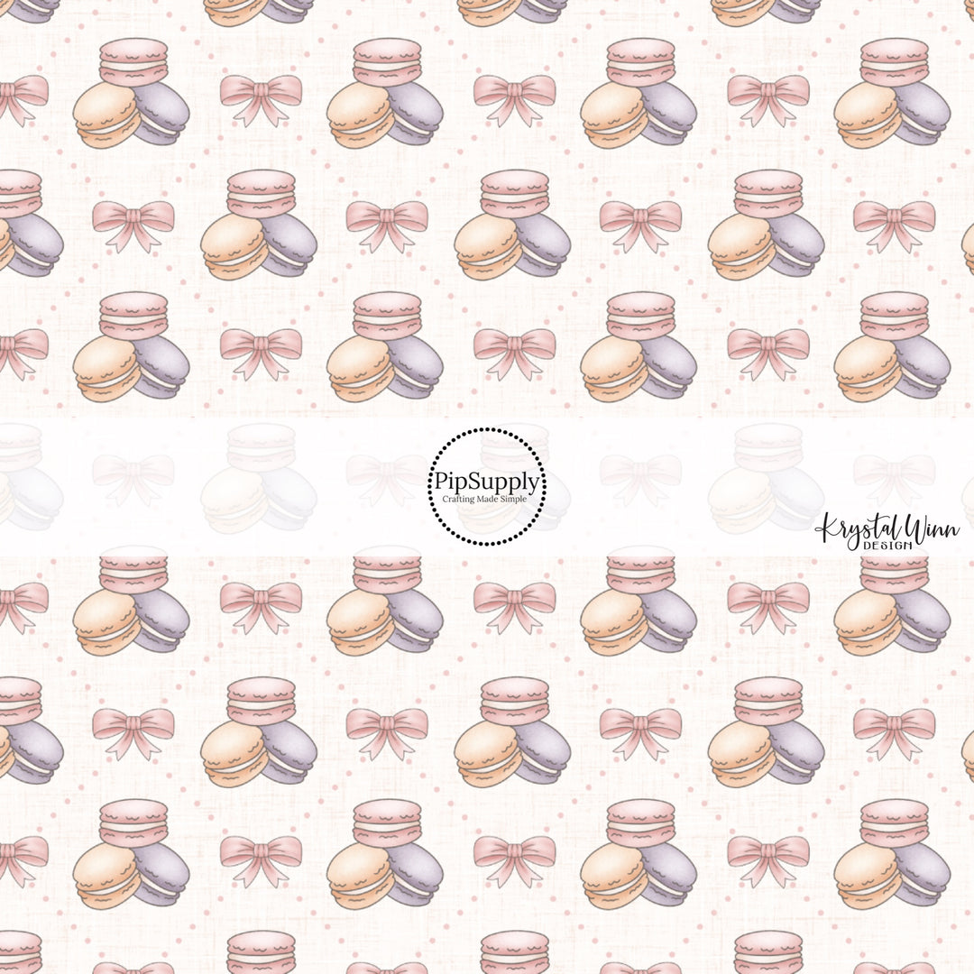 This Easter fabric by the yard features pink bows and pastel macaroons. This fun pattern fabric can be used for all your sewing and crafting needs!