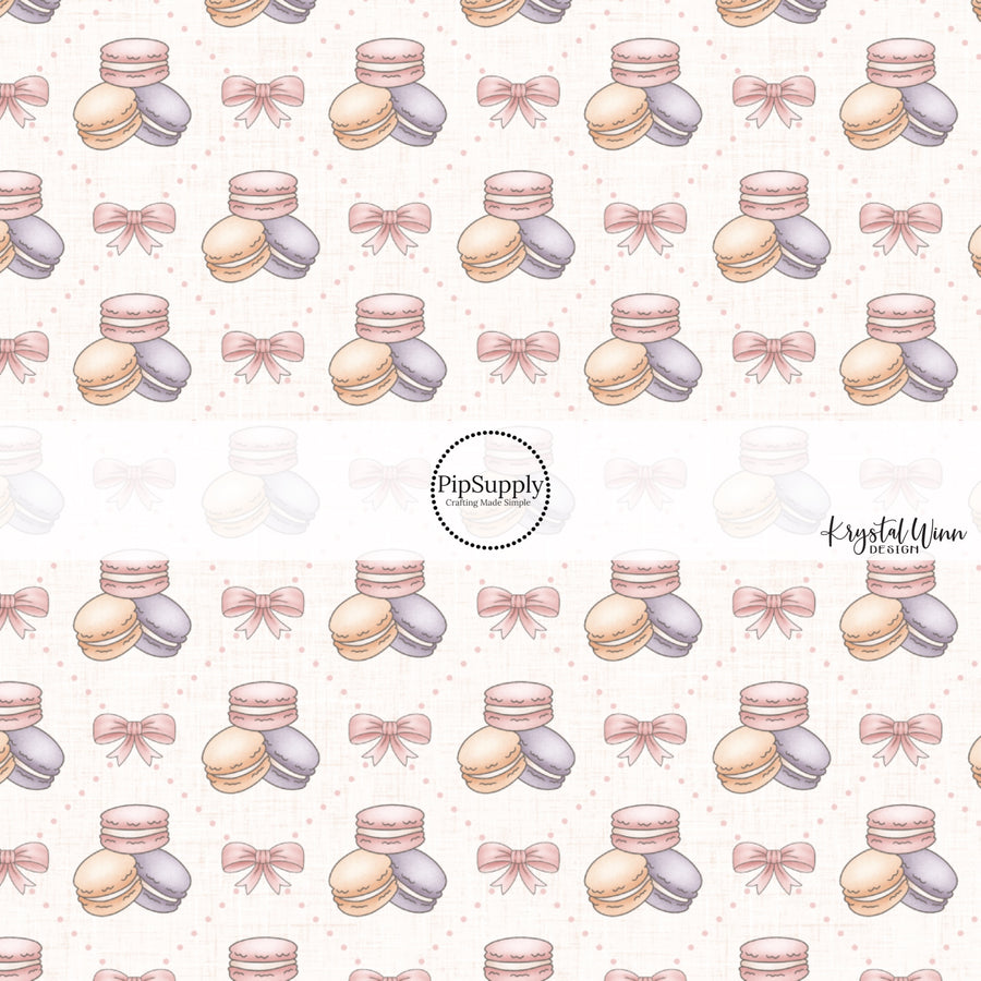 This Easter fabric by the yard features pink bows and pastel macaroons. This fun pattern fabric can be used for all your sewing and crafting needs!