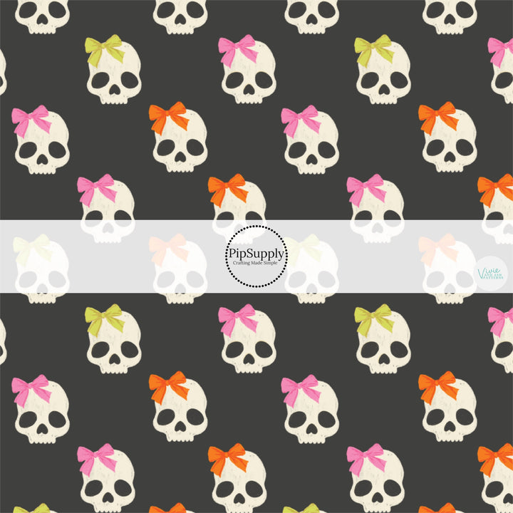 These Halloween themed pattern fabric by the yard features the following design elements: white skulls with bows on gray. This fun themed fabric can be used for all your sewing and crafting needs!