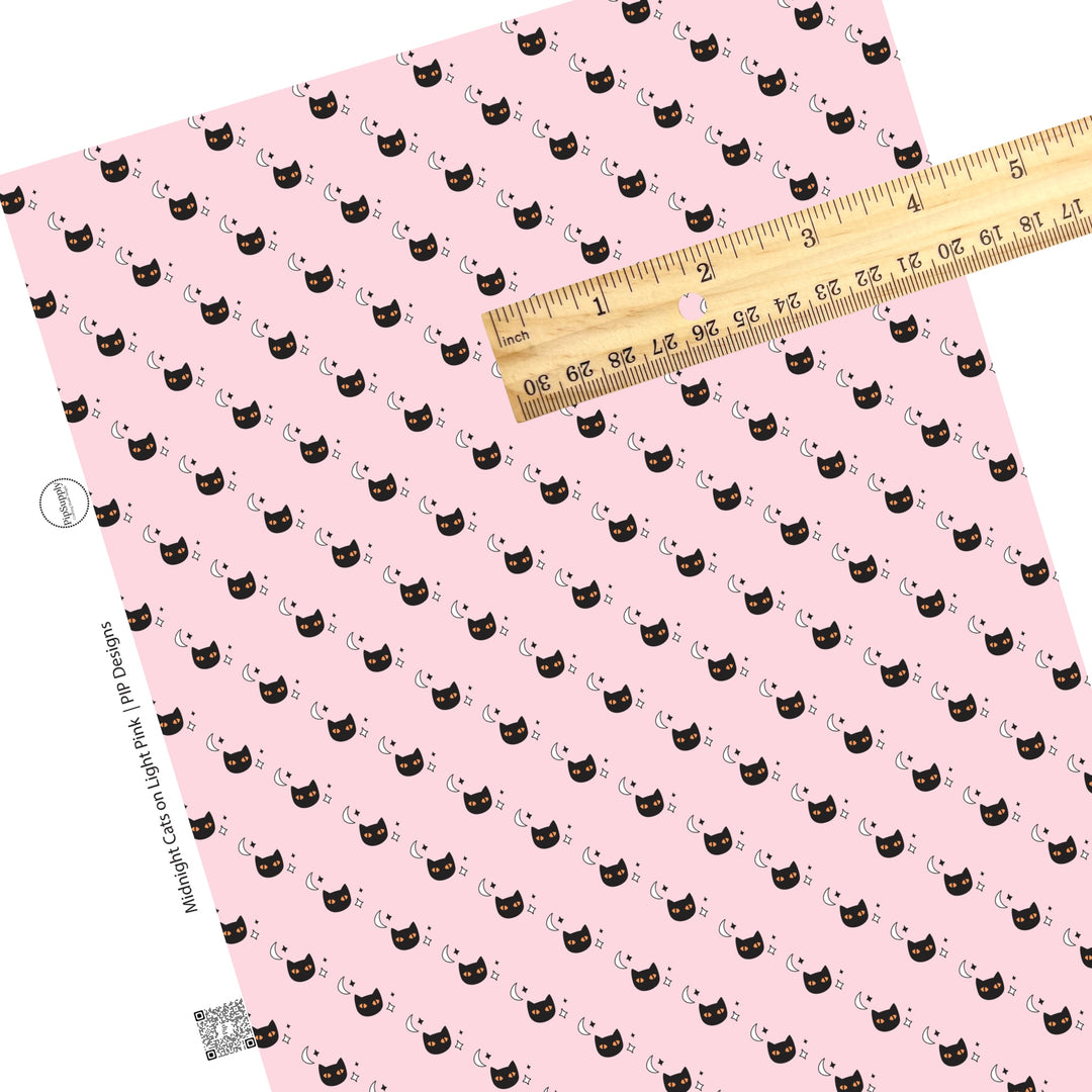 Moons and stars with cats on light pink faux leather sheets