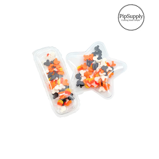 Black, white, and orange mouse heads with candy corn shaker clip cover