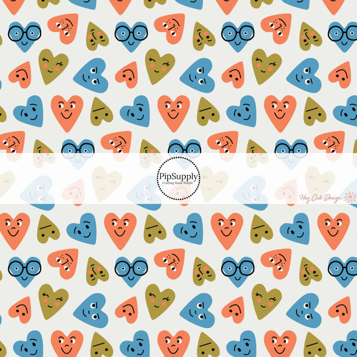 This holiday fabric by the yard features blue, orange, and green smiley hearts. This festive pattern fabric can be used for all your sewing and crafting needs!