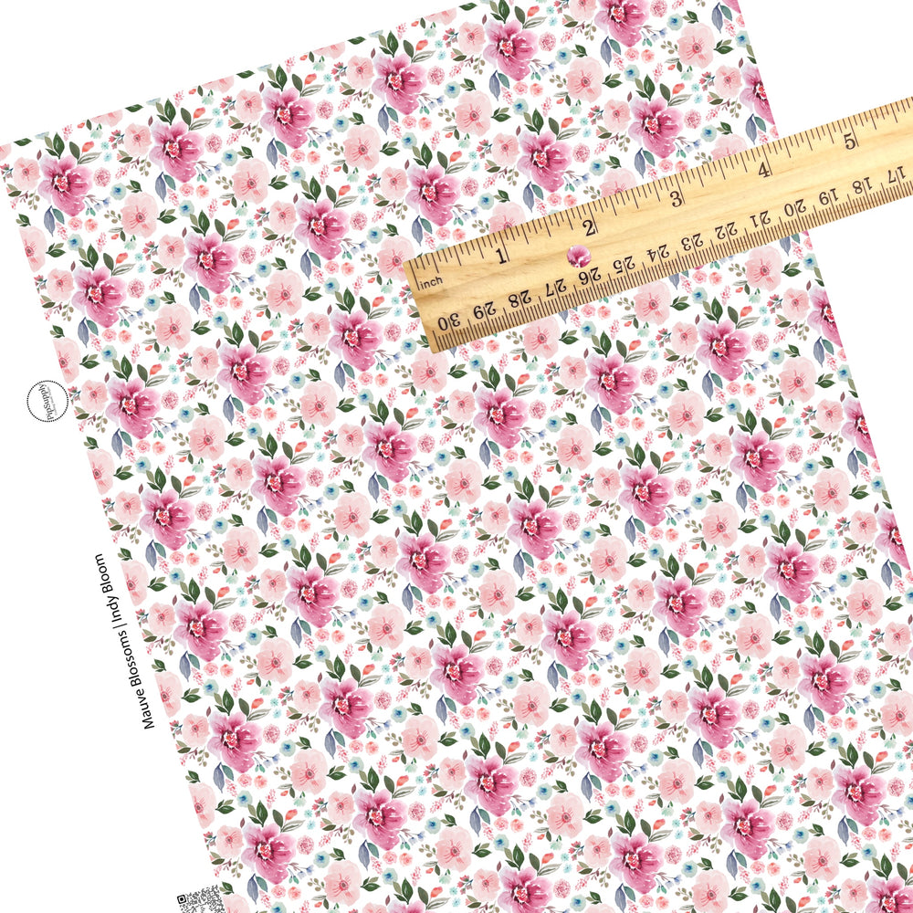 These pastel watercolor flowers on a white faux leather sheets contain the following design elements: light pink, peach, blue, teal, purple, green, and olive beautiful flowers and leaves.