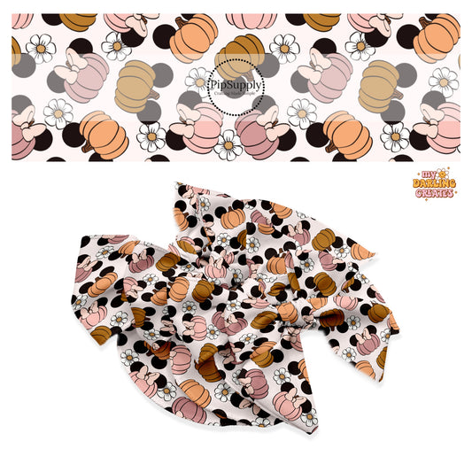 Brown, orange, mauve, and pink mouse head pumpkins with flowers on cream hair bow strips