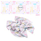 These Valentine's pattern no sew bow strips can be easily tied and attached to a clip for a finished hair bow. These Valentine's Day bow strips are great for personal use or to sell. The bow strips feature pink, blue, purple, and yellow hearts and bows on light pink.